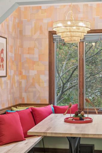 Breakfast nook with oak-trimmed window and built-in banquette seating.