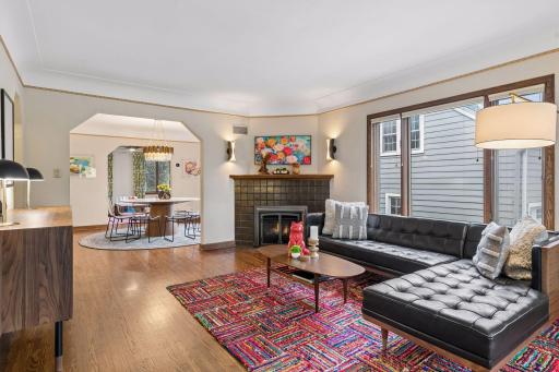 Living room with original tile fireplace, Valor gas insert, and arched opening to the dining room.