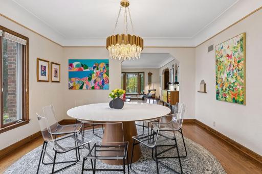 Dining room with arched niche, plaster crown, and side window.
