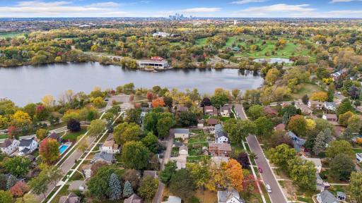 Aerial of Como Lake, Como Lakeside Pavilion, and Como Regional Park with the city skyline on the horizon.