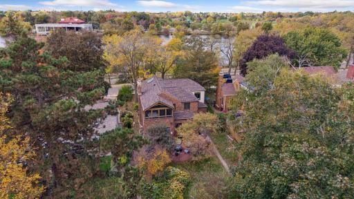 Aerial view of the rear of the home with Como Lake beyond the treeline in St. Paul.