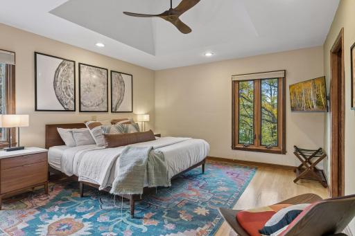 Primary bedroom with recessed lighting, arched wall niche, and wood floors.