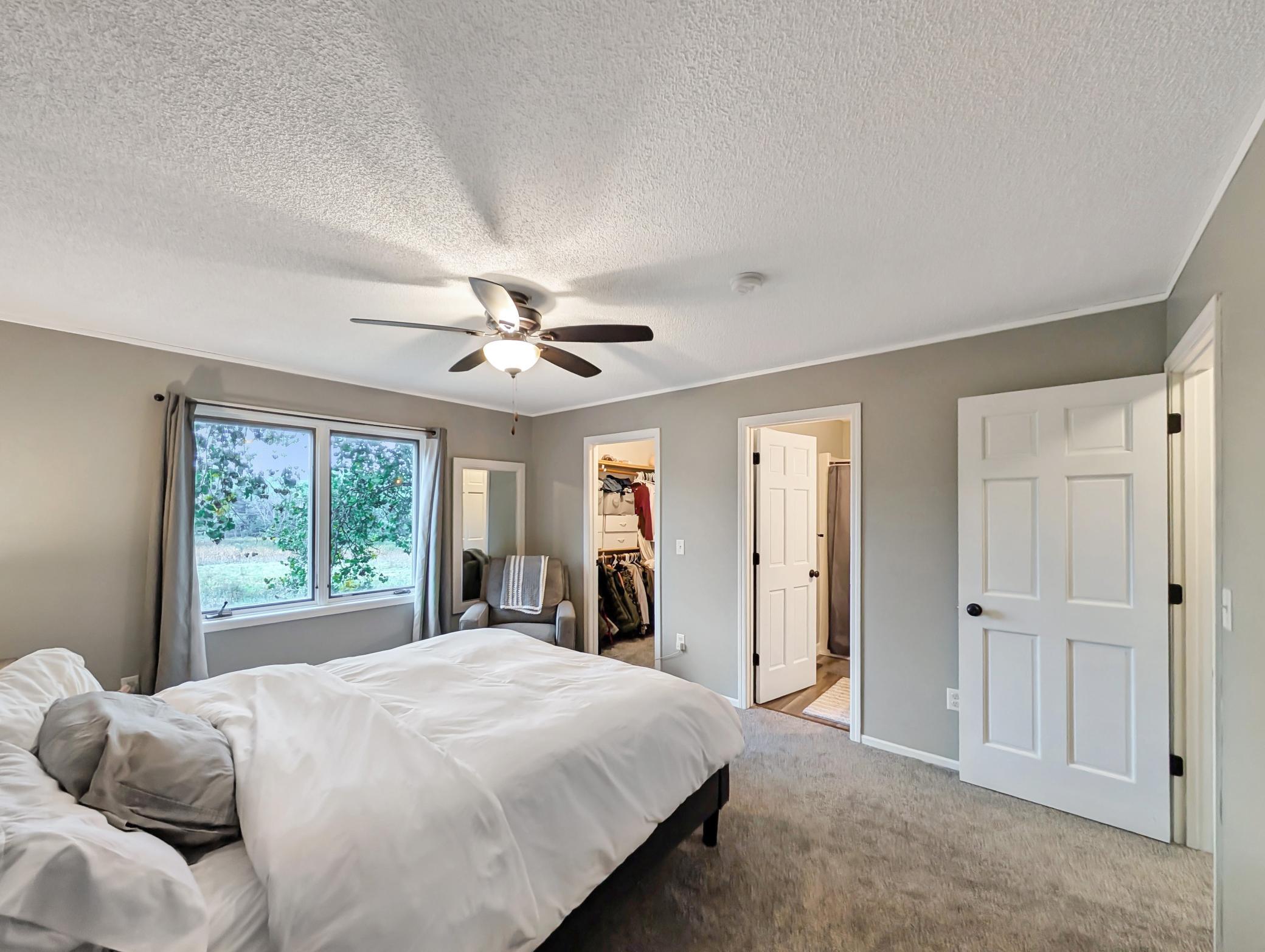 Features a walk-in closet and attached bathroom.