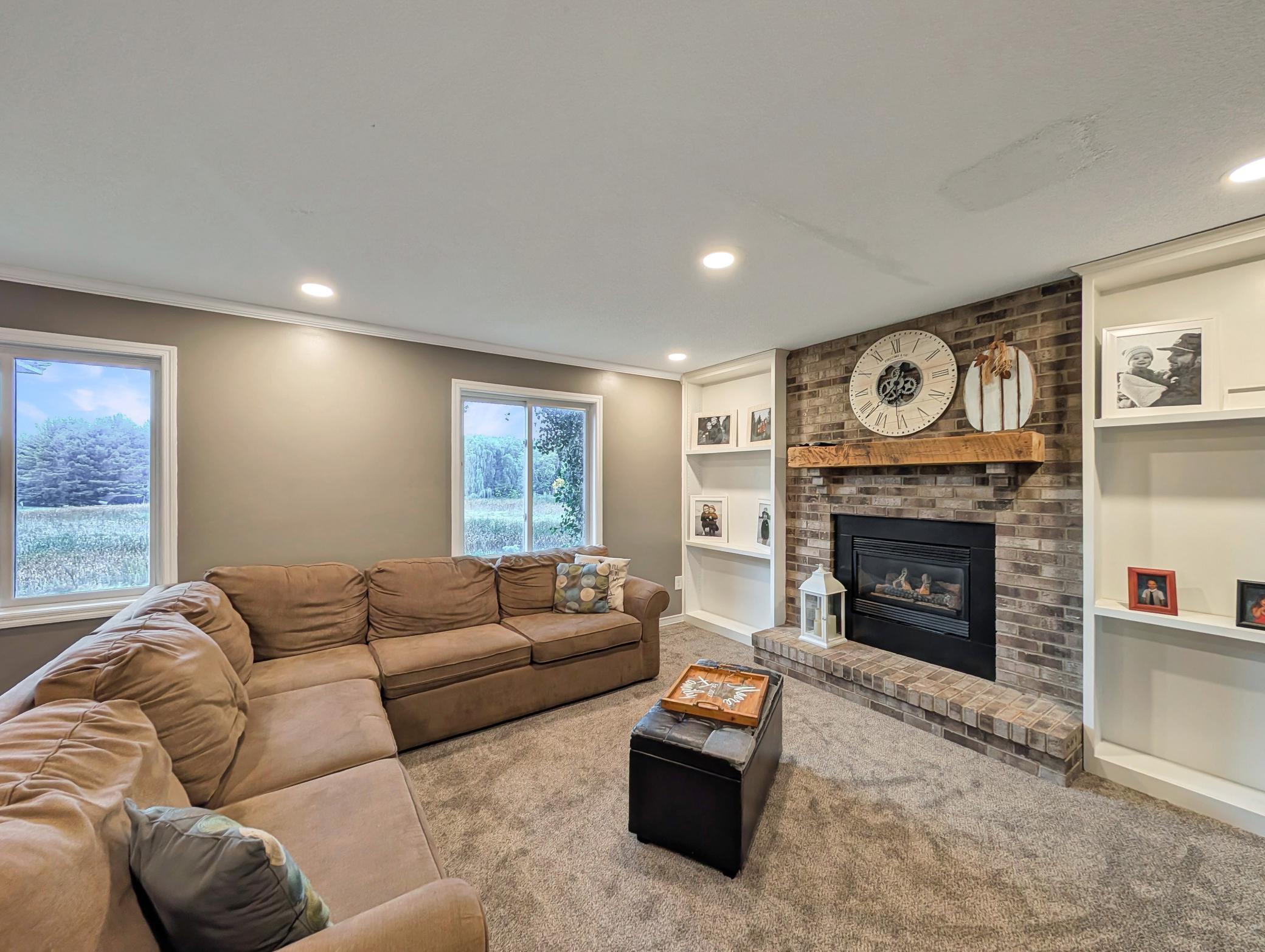 Cozy family room with a beautiful fireplace and built-ins for storage and display!