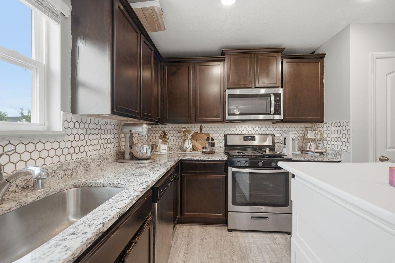 Large kitchen area with upgraded counters/backsplash
