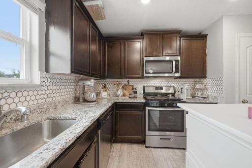 Large kitchen area with upgraded counters/backsplash
