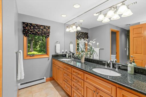 Primary bath, featuring dual vanities, and a large walk-in shower.