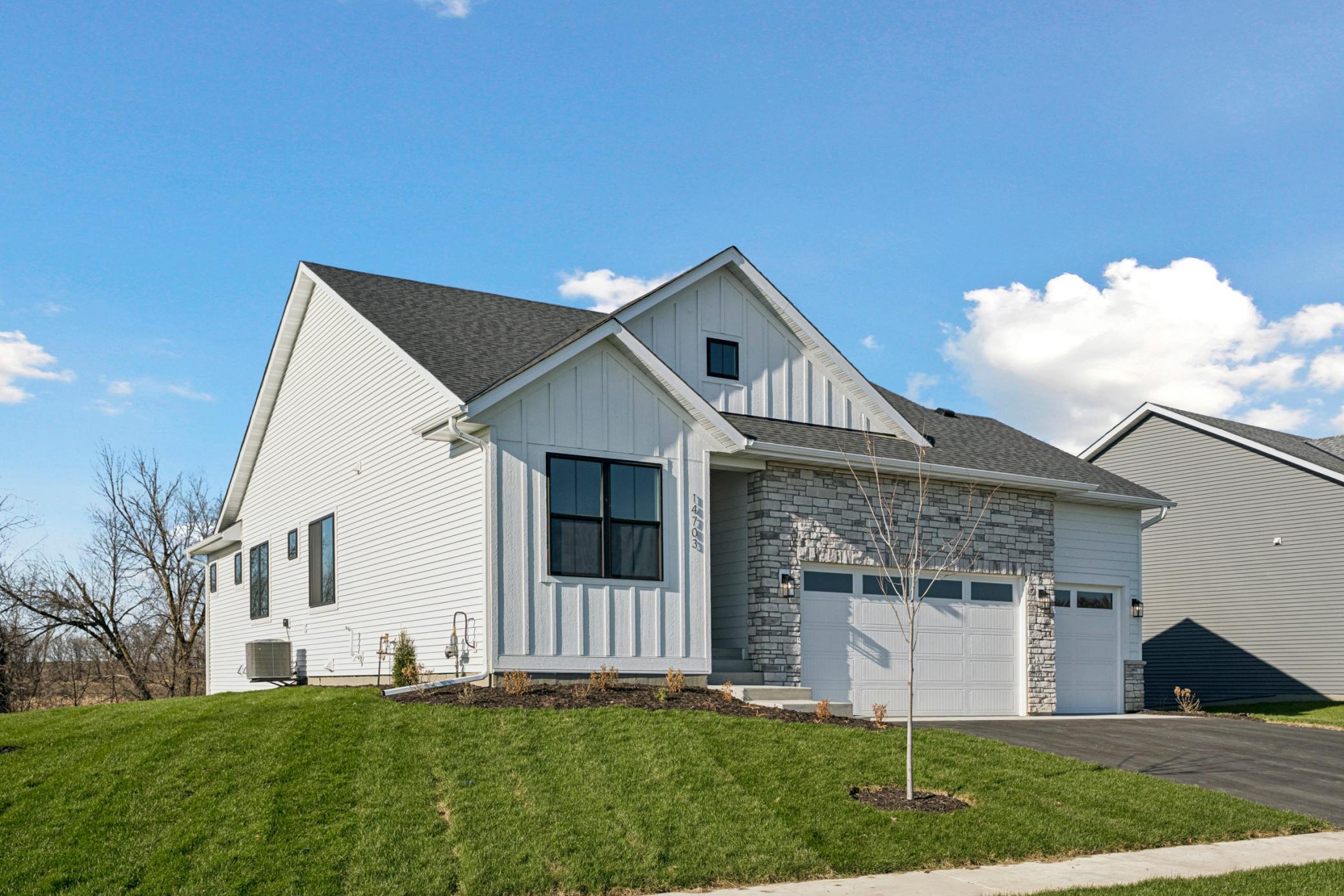 RW03002001 – Kendall A – 14703 Kingsview Lane North, Front exterior siding features L.P. Smart-side! And Oversized 3-car Garage!