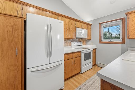 Kitchen features a new dishwasher, track lighting, upper cabinet lighting and eat in dining area.