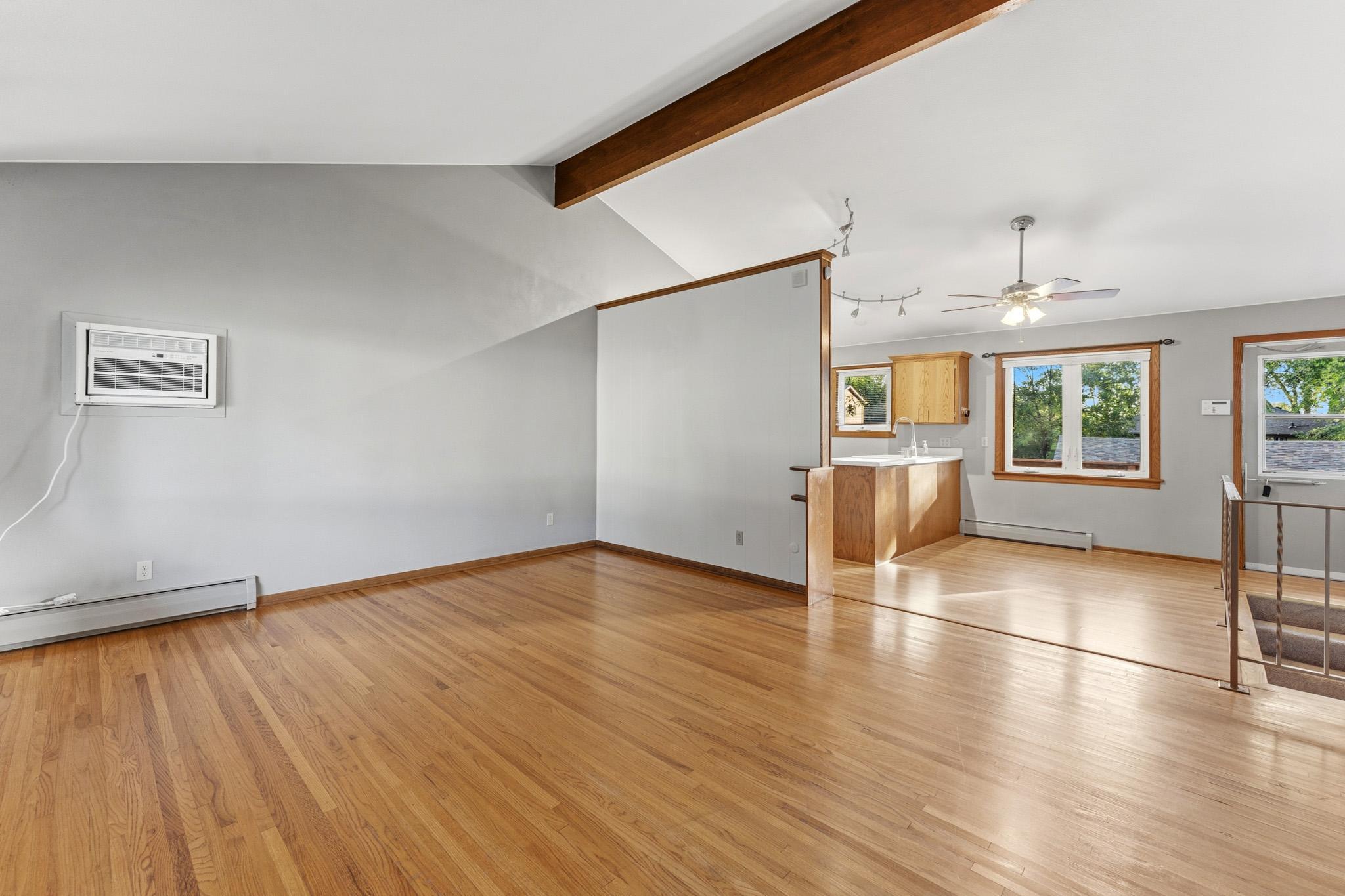 Open Floor Plan with vaulted ceilings. Spacious Living Room with beautiful hardwood floors throughout the home and new window AC