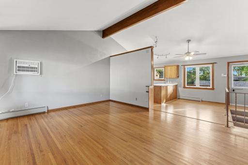 Open Floor Plan with vaulted ceilings. Spacious Living Room with beautiful hardwood floors throughout the home and new window AC