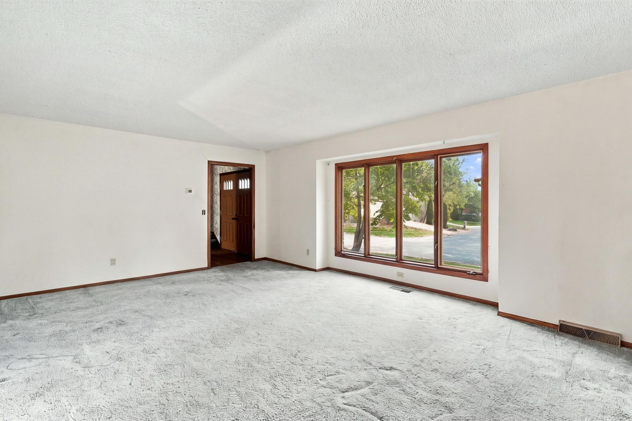 Formal living room offers space to relax, entertain, and make your own.