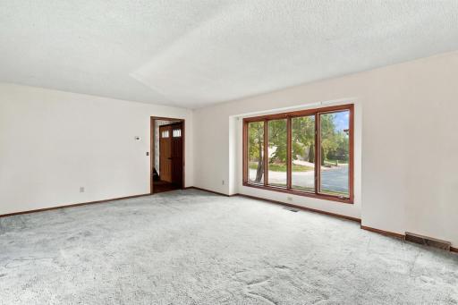 Formal living room offers space to relax, entertain, and make your own.
