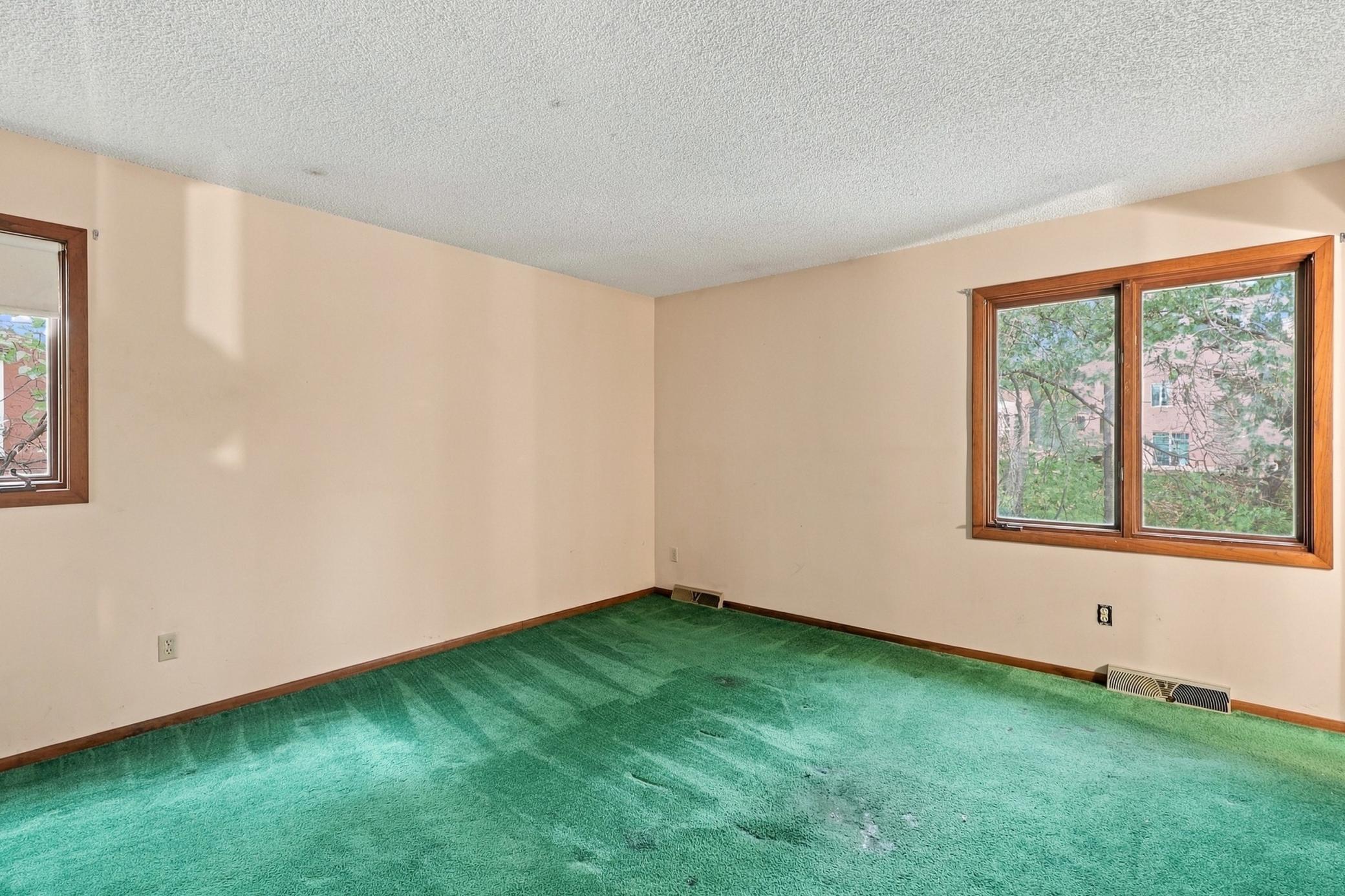 Primary bedroom offers a private retreat with an adjoining bathroom.