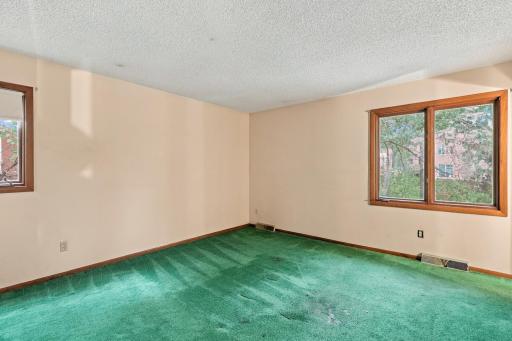 Primary bedroom offers a private retreat with an adjoining bathroom.