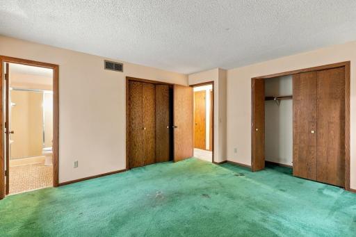 Spacious primary bedroom features a private three-quarter bathroom.