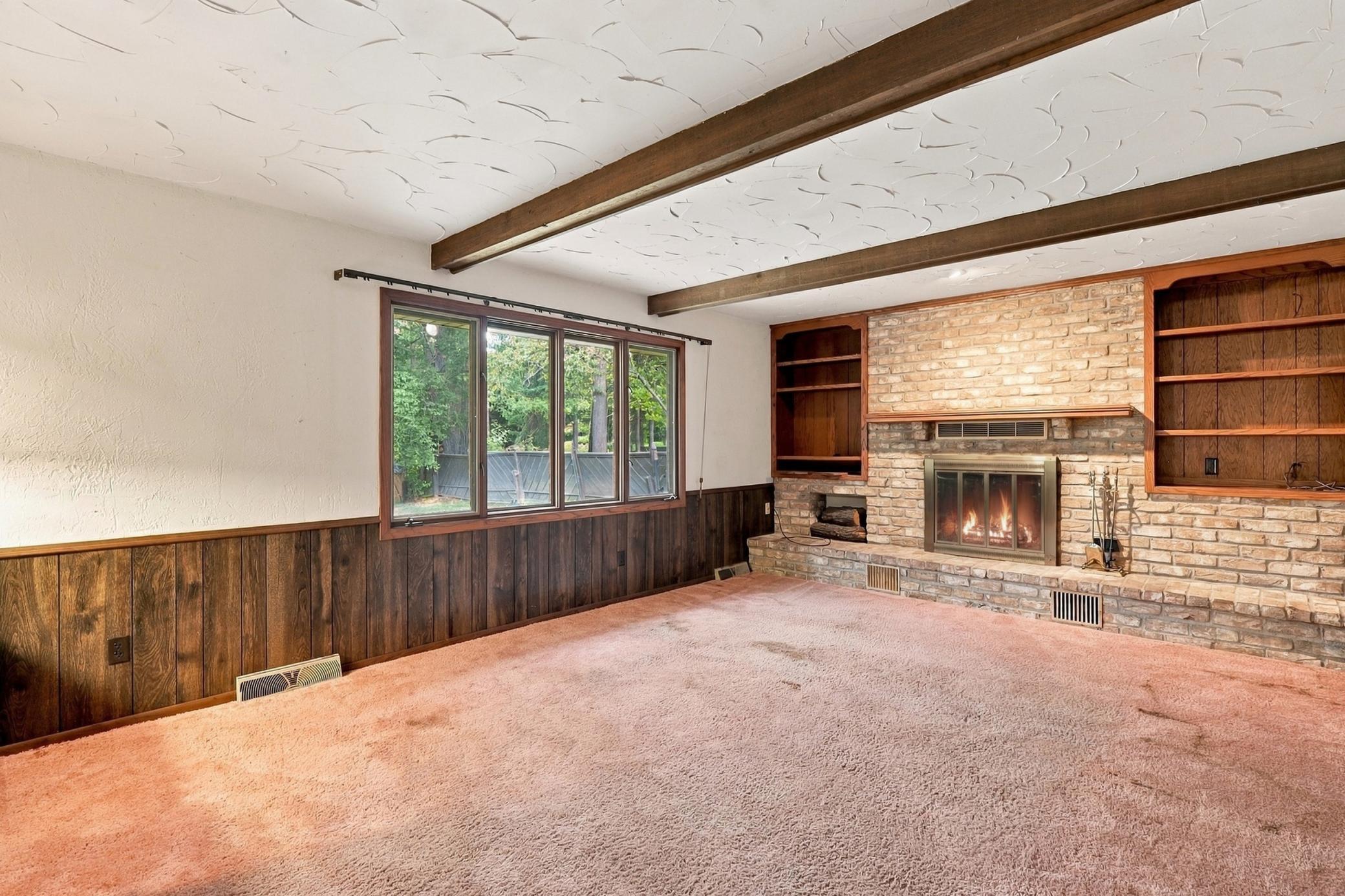Family room features a wood-burning fireplace for a classic gathering space.