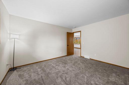 Bedroom 1 features fresh carpet and a fresh coat of paint.