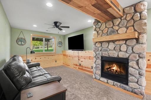Almost new lower-level family room with stunning stone gas fireplace