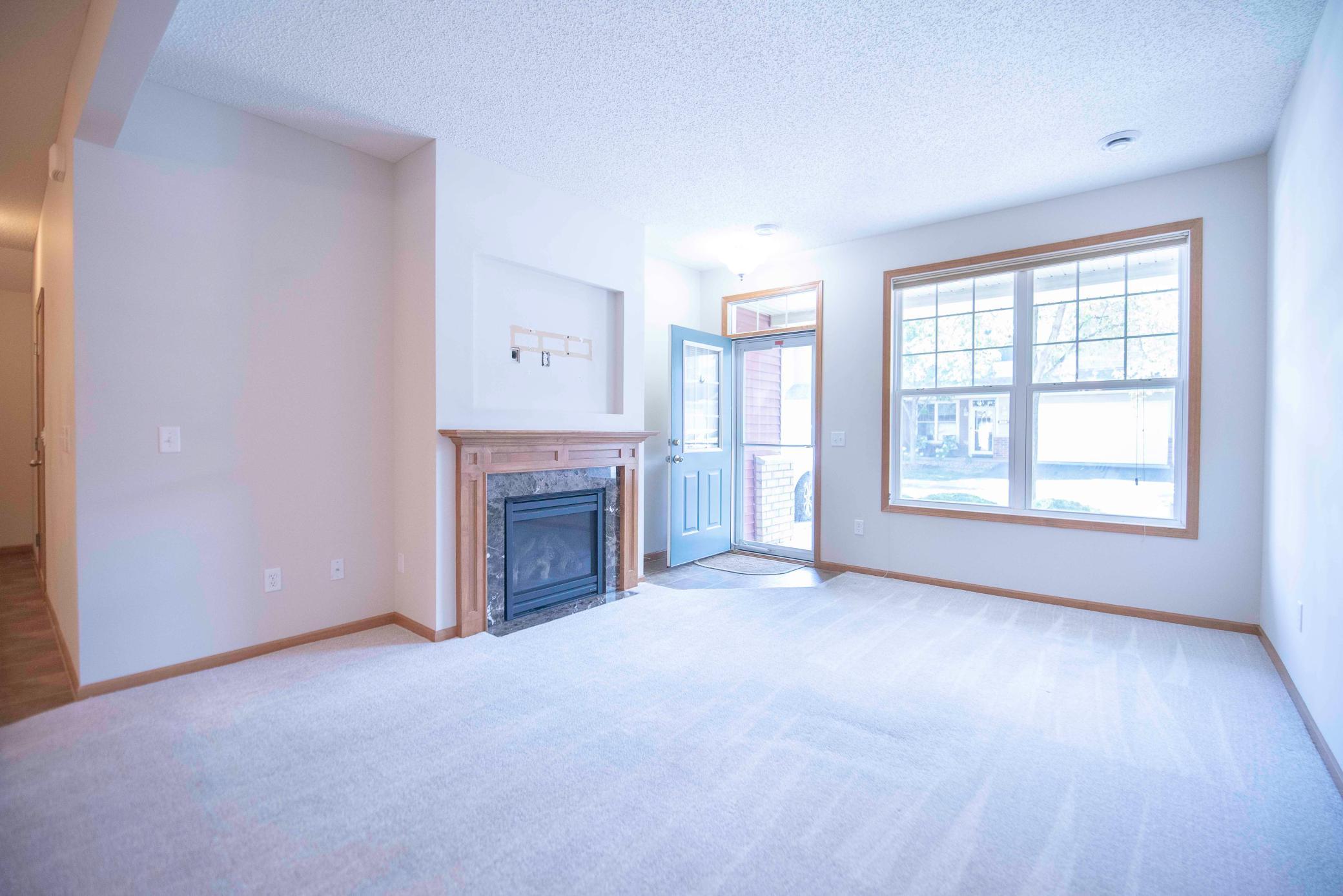 Living Room with gas fireplace right off front entry