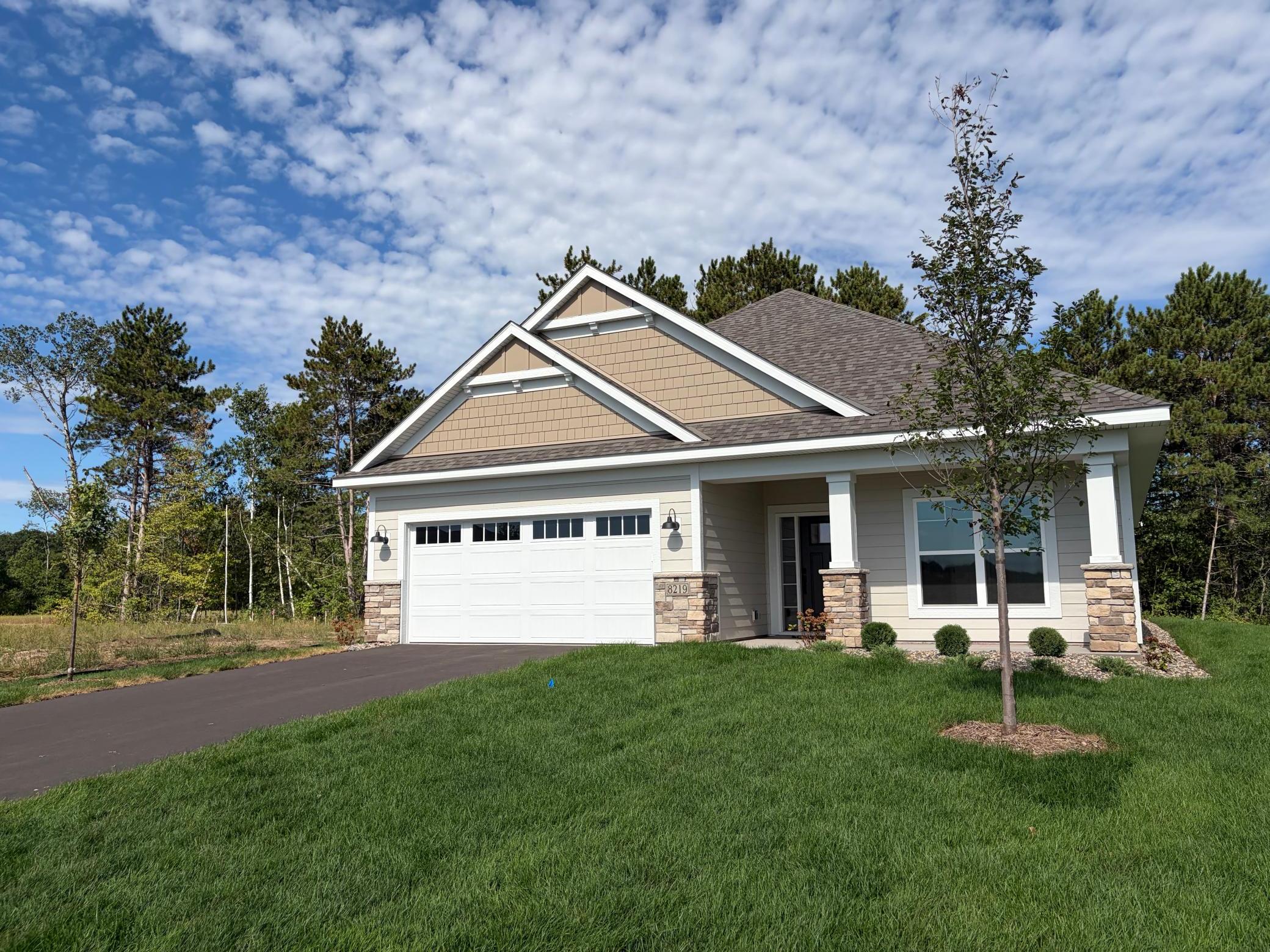 Pulling up to the home you can see beautiful landscape and mature trees!