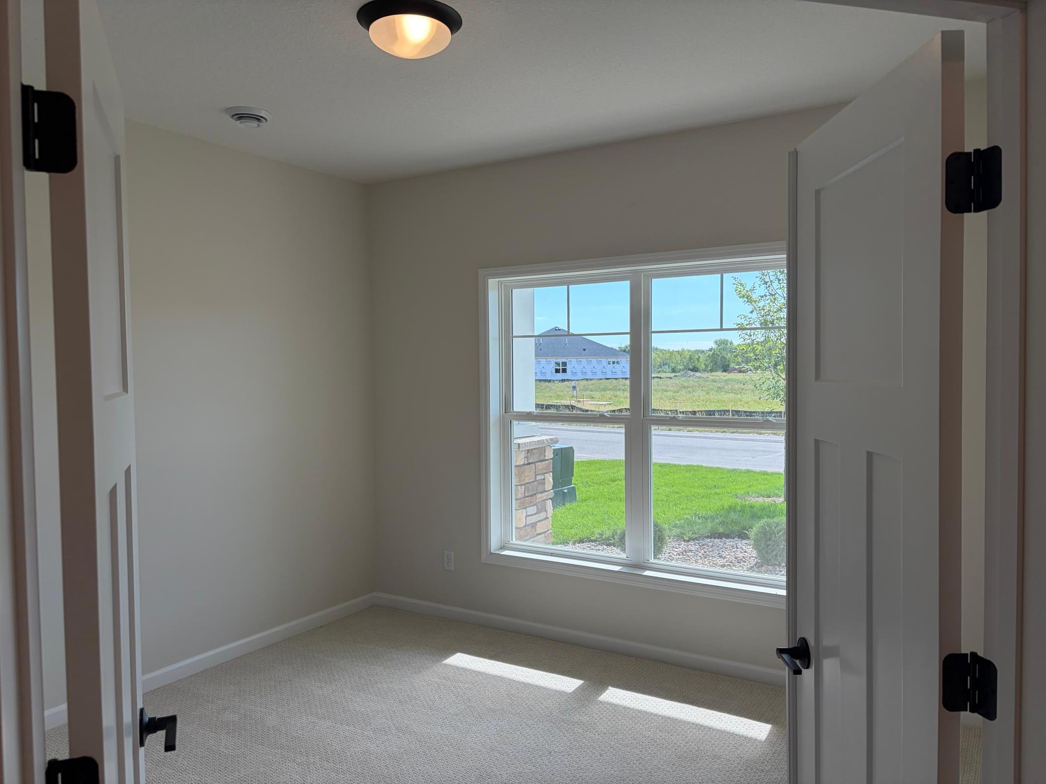 Featuring French doors the immediate bedroom is spacious enough for an office, queen size bed or a secondary den.