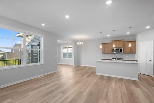 Family Room- view to kitchen/dining and morning room (sunroom) beyond. Similar home.
