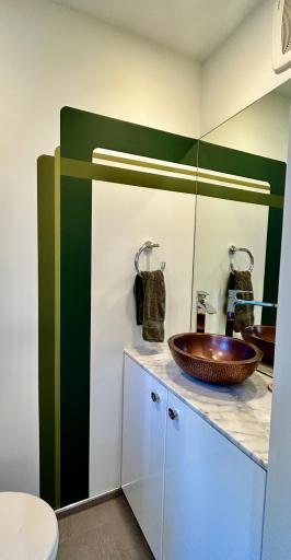 Main level half bath w/ a window & more artistry.