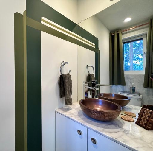 Main level half bath w/ a window & more artistry.