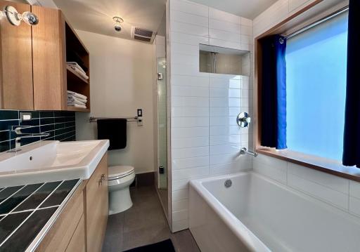 Upper level full bath. Oh, the tile & custom cabinetry & windows.