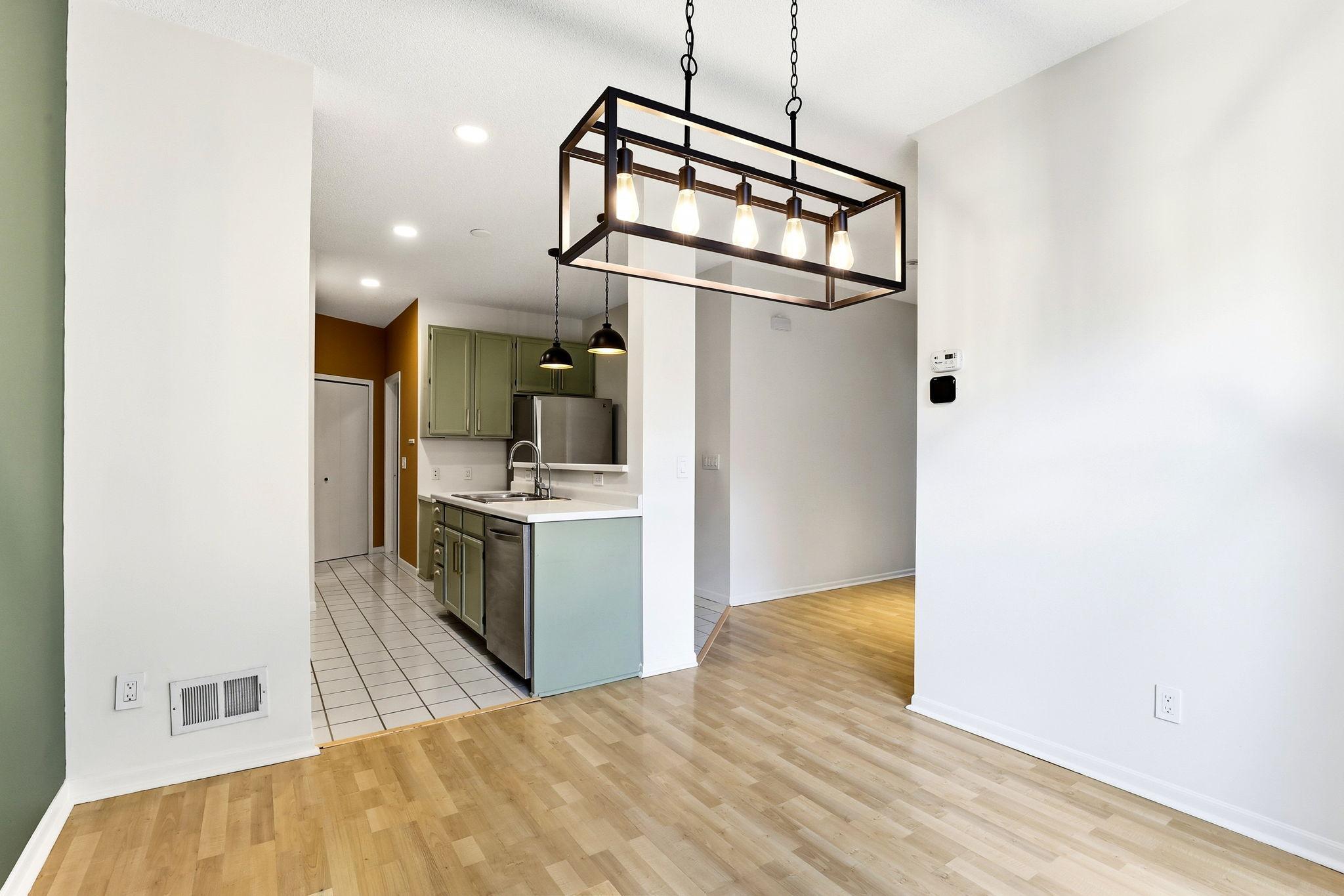 Transition into the kitchen where easy-to-maintain tile flooring meets the dining space. The open sightlines make this layout ideal for staying connected while cooking or entertaining.