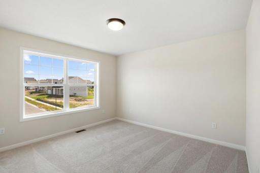 The owner's suite on the upper level serves as a relaxing sanctuary. *Model home photos, colors and selections may vary.*