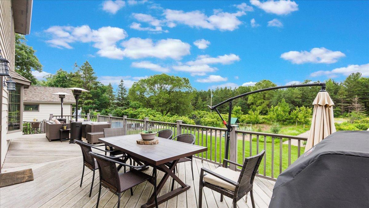 Wrap-around deck overlooking backyard & pool.