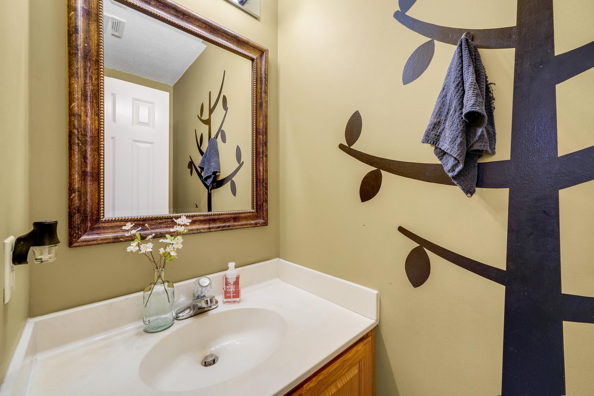 Main level 1/2 bathroom is spaced just off the kitchen, and close to the garage.