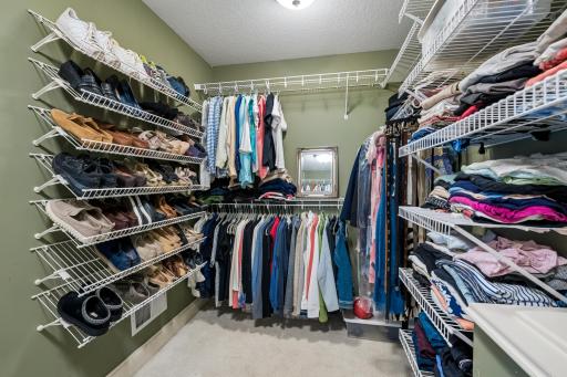 Walk-in primary closet with built-ins and laundry chute, plus an adjacent bonus closet