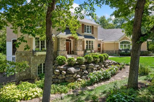 Landscaped front and walking path around to the backyard