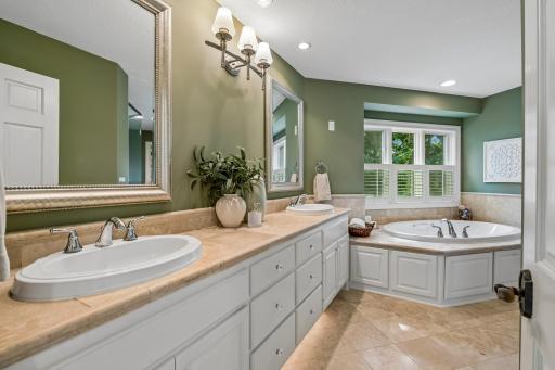 Luxurious bath with heated floors, double vanity and windows above the jetted tub
