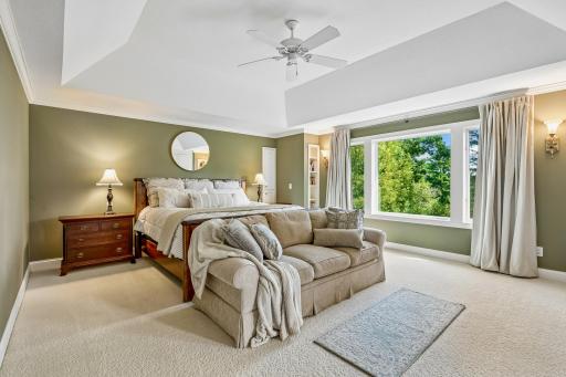 Spacious primary suite with tray ceilings, set amongst the treetops