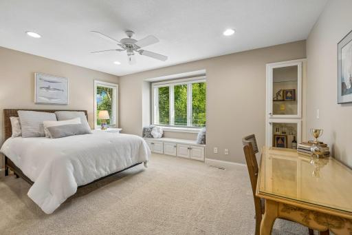 Upper level second bedroom features lighted double display case for treasures, and bench seating overlooking the backyard