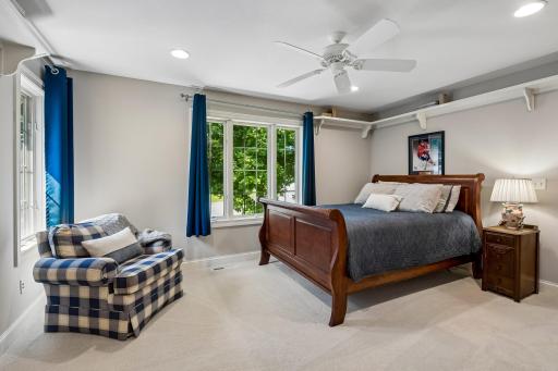Inviting fourth upper level bedroom ensuite feels unique with its own display shelving, 3/4 bath, tiled floors and walk-in closet