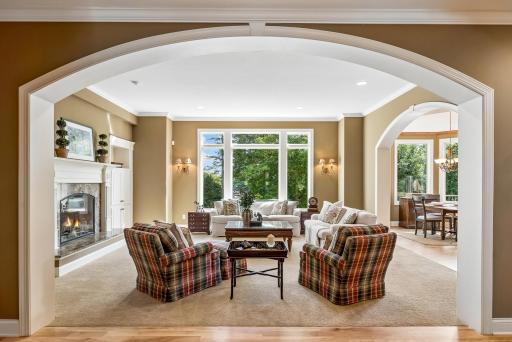 Arched entry into living room filled with natural light