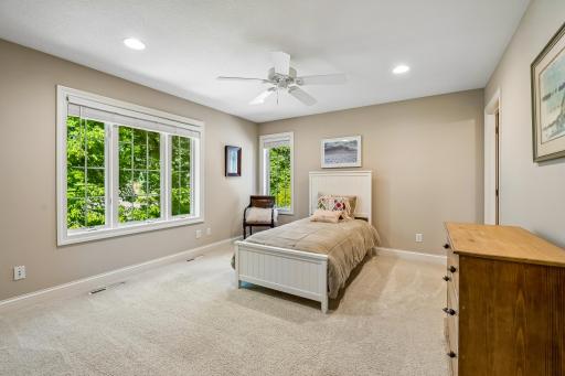 Upper level comfortable third bedroom with windows and fan