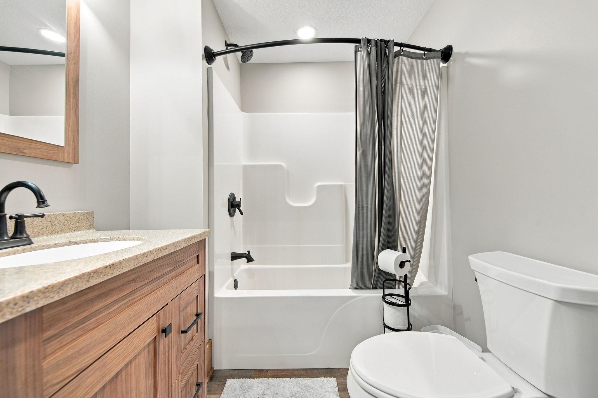 Private full bathroom connected to the main floor bedroom.