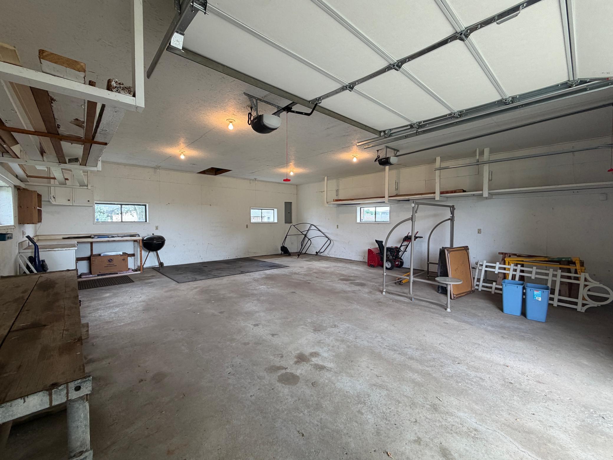 Shed is complete with concrete floor, garage door opener, and lots of extra storage.