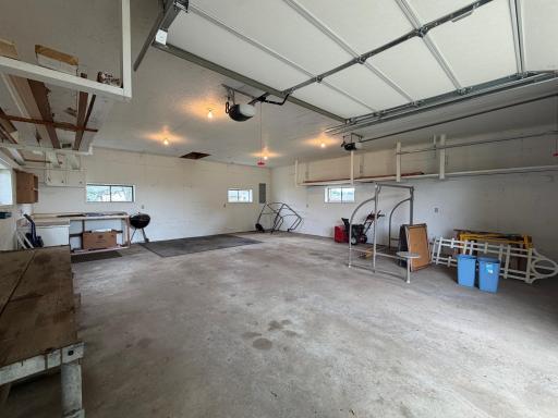 Shed is complete with concrete floor, garage door opener, and lots of extra storage.