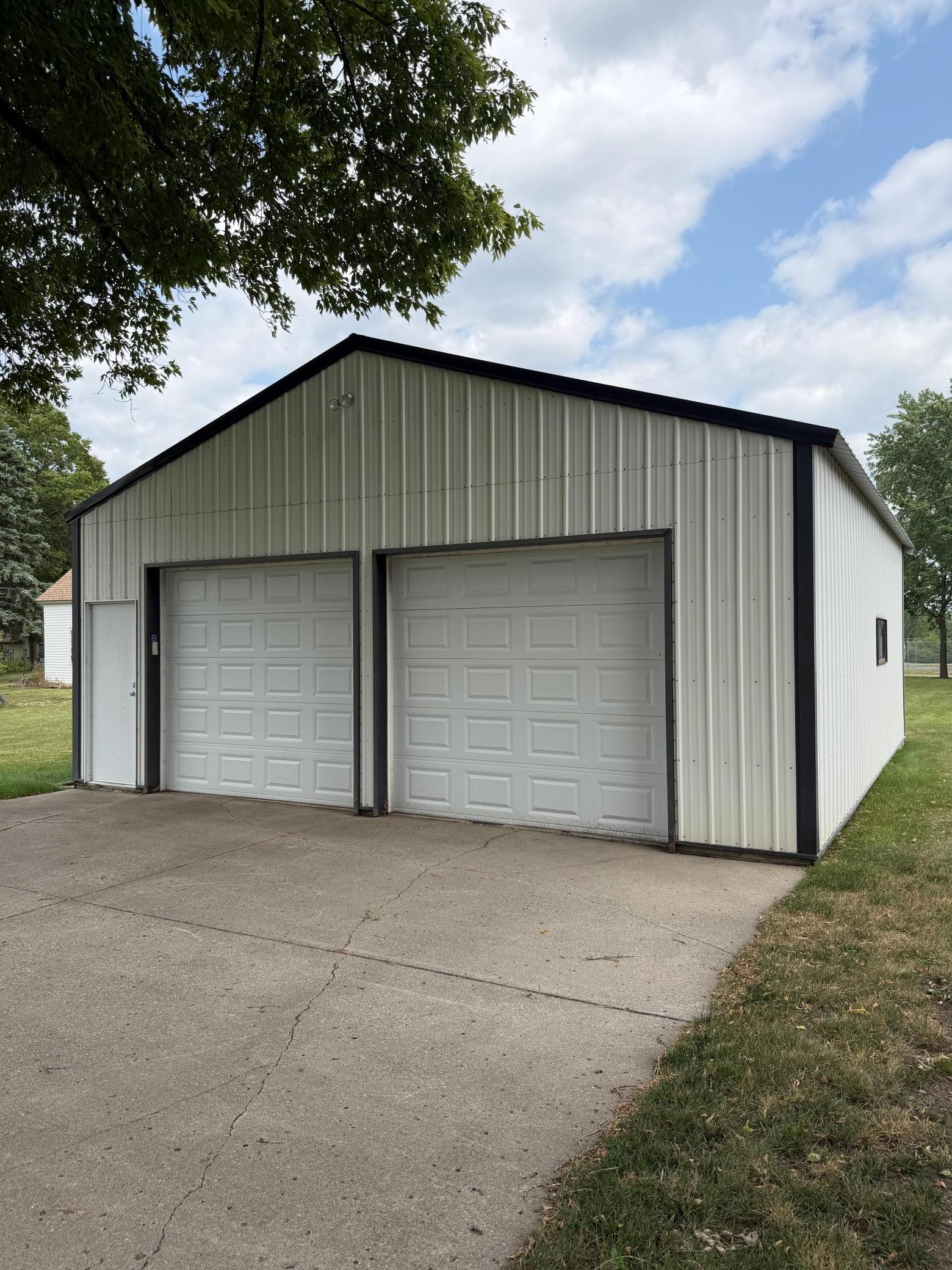 Existing 2 car shed is 26 x 30, with concrete pad and service door.