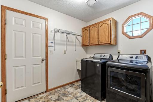 Main-level laundry room with direct garage access for efficient, everyday convenience.