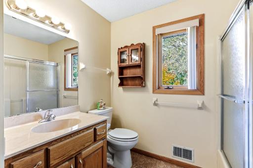 Full upper-level bath offering bright, functional space for everyday comfort.