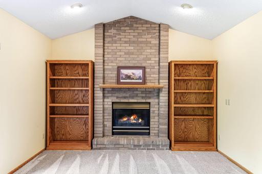 Family room featuring a brick-surround gas fireplace that adds warmth, character, and a timeless focal point.