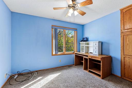 One of two additional upper-level bedrooms offering comfortable space for family, guests, or flexible use.